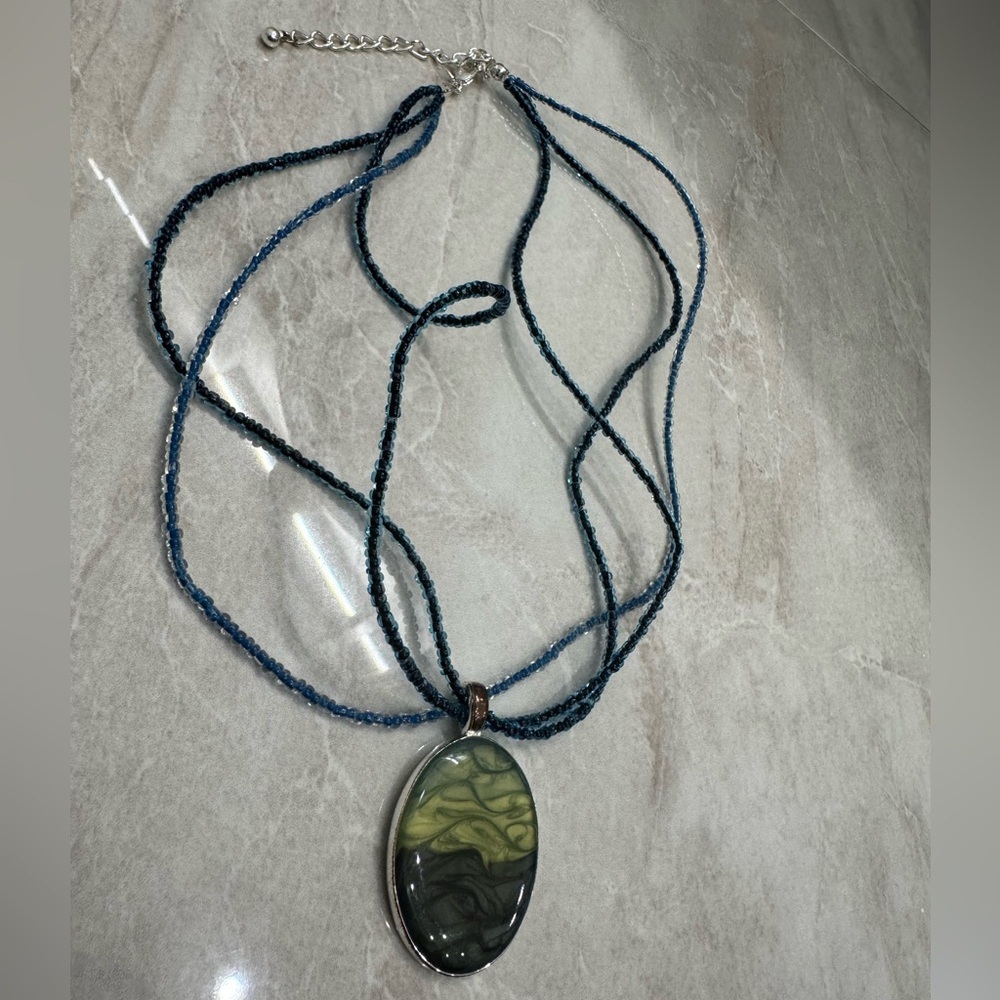one-of-a-kind necklace with a beautiful green and black stone pendant